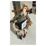 Ragdoll with bear on rocking chair