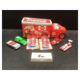 Vintage Coca Cola cars and a tin truck canister