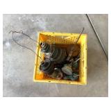 Crate of oil cans and fly wheels