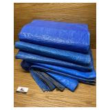 Four large blue tarps