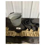 Metal bucket, ammo belt, and lead rope