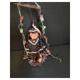 Native American Porcelain doll on swing
