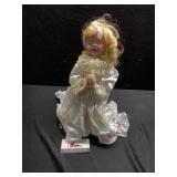 Porcelain praying doll