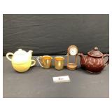 Tea pots, clock, and metal cup and pitcher
