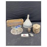 Saw blades, cheese box, funnel, and pulleys