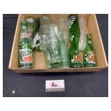 Vintage Coca-Cola, sprite, and 7up glass bottles