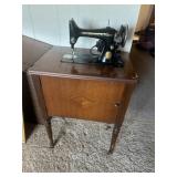 Singer sewing machine in stand