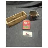 Cheese box, enamel mug, tobacco tin