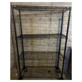 Black metal shelf on casters