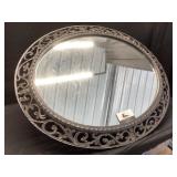 Oval ornate black framed mirror