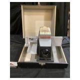 Bow and Howell slide projector turns on