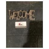 Cast-iron welcome sign