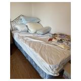 Twin size bed with extra pillows and blankets
