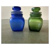 Blue and green glass bottles with lids