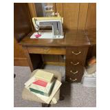 Singer sewing machine in cabinet with stool and