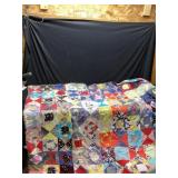 Hand stitched quilt. 84 x 63.