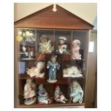 Display cabinet full of Ashton Drake dolls