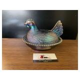 Iridescent hen on a nest dish