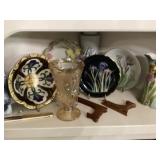 Shelf full of decorative plates, vases, etc.