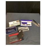 Assorted pens, letter openers, and wallet
