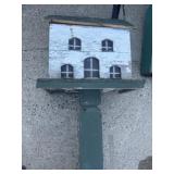 Ornate birdhouse on stand