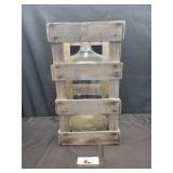 Wooden crate with large glass jar