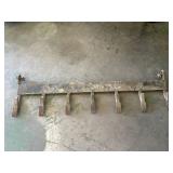 Tooth attachment for skid loader bucket