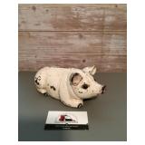 Vintage white cast-iron piggy bank with a