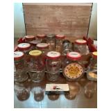 Assorted glass coin banks with lids