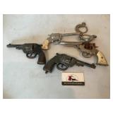 Vintage toy pistols and handcuffs
