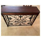 Console table with ornate metal panel