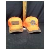 Orange shields, outfitters cap, and pheasants