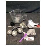 Measuring cups and a fire king glass measuring