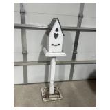 Wooden birdhouse on stand