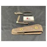 Tools in leather pouch marked US Army