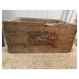 Wooden crate with horse shoes