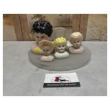 Doll heads on serving platter