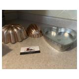 Copper colored molds and heart pans