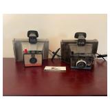 Two Polaroid cameras