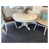 Primitive wooden table, plastic chairs, and decor