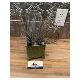 Metal box full of whisk