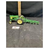 John Deere tractor with plow