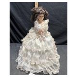Porcelain doll approximately 24 inches tall
