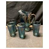 Carnival glass water, pitcher, and glasses