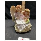 Angels looking over sleeping baby figurine