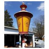 Shell stenciled light fixture on pole.