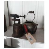 Torch and metal kettle.