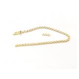 7.9g 14k yg tennis bracelet with several clear