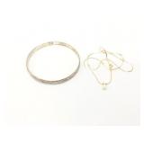 1.4g 14k yg thin chain that has 1 small white