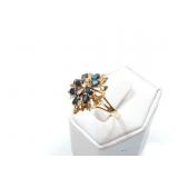 4.6g 14k yg ring with several blue chips and 3